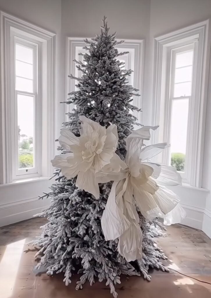 Dramatic non-traditional Christmas tree with floral decorations and festive seasonal style