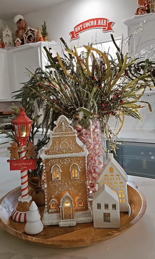 Gingerbread Lane tray styled as a hot cocoa bar with gingerbread houses, striped straws, and peppermint candy accents.
