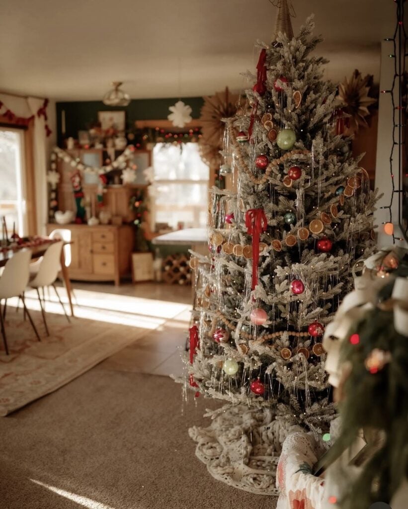 Nature-inspired Winter Solstice tree decorated with dried citrus, evergreen branches, wooden ornaments, and celestial accents for a peaceful Yule display.