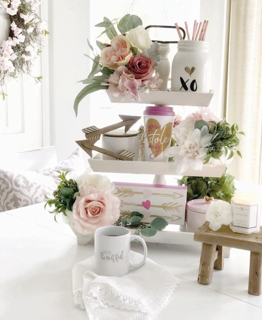 Cozy Valentine tiered tray in soft pink and cream with heart decor, florals, and greenery.