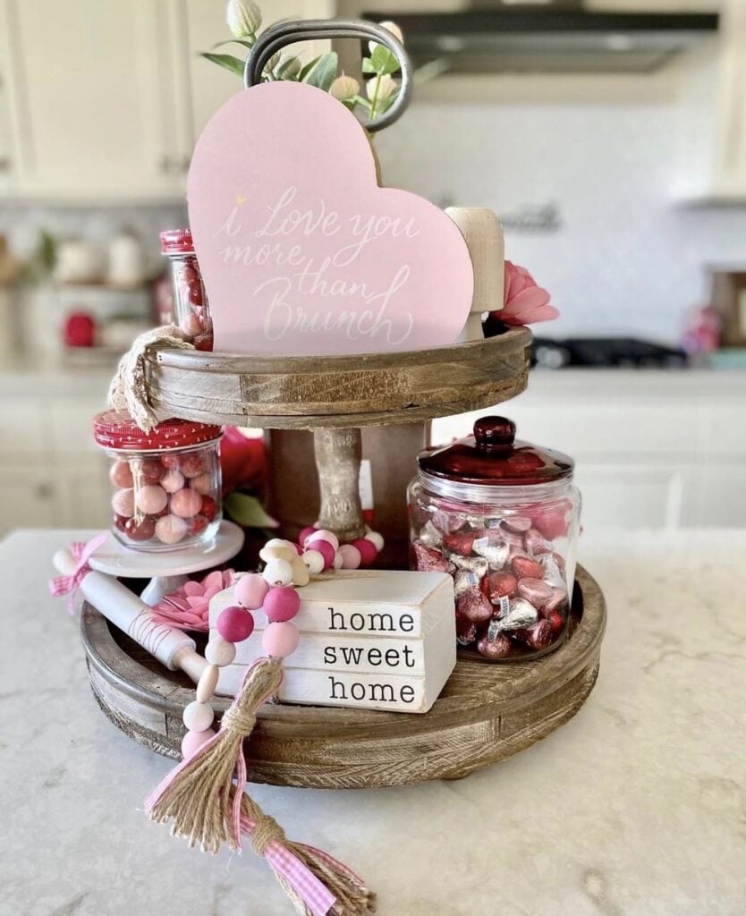 Valentine’s tiered tray decor with layered hearts, flowers, greenery, and romantic accents.