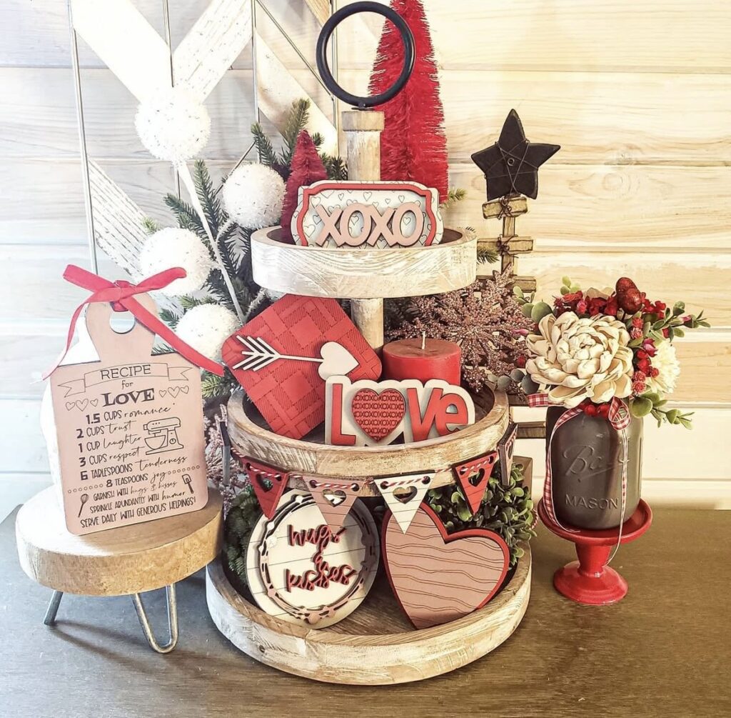 Farmhouse Valentine tiered tray featuring hearts, flowers, greenery, and sweet treat decor.