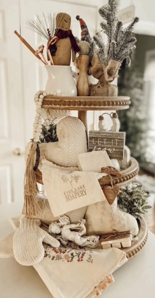 Neutral farmhouse Valentine tiered tray with simple hearts, florals, greenery, and candy pops.