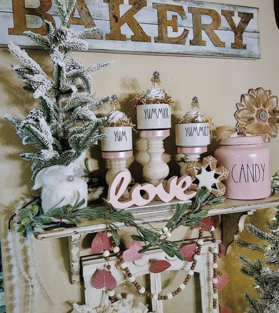 Cozy valentines shelf with sign in light pink that says love and a sign on the wall that says bakery