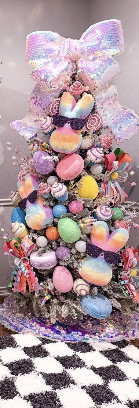Candy themed Easter tree decorated with rainbow Peeps wearing sunglasses, pastel glitter eggs, and a huge sparkly bow topper.