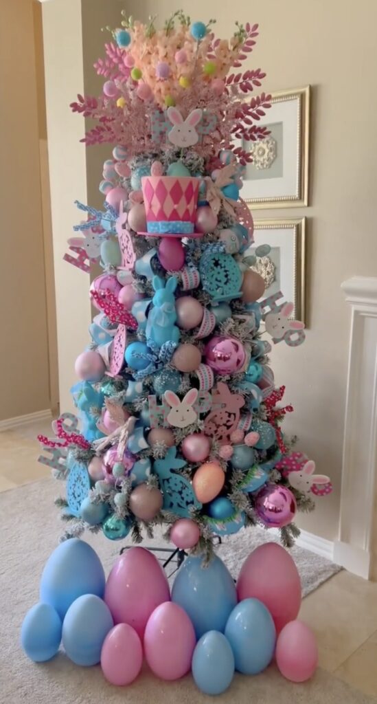 Easter tree decorated with pastel ornaments, bunny cutouts, and colorful egg decorations around the tree base.