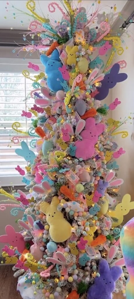 Whimsical Easter tree filled with pastel Peeps bunny decorations, Easter eggs, carrot picks, and bright candy-colored accents