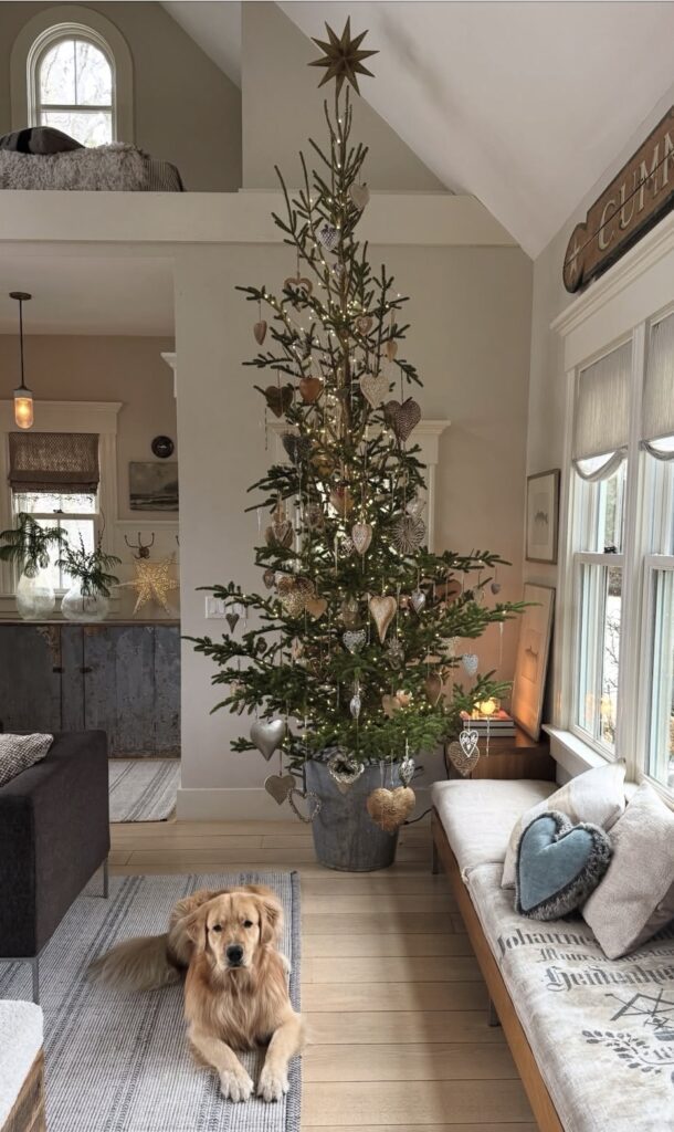 Christmas tree decorated unusually with rustic heart shaped ornaments and festive holiday style