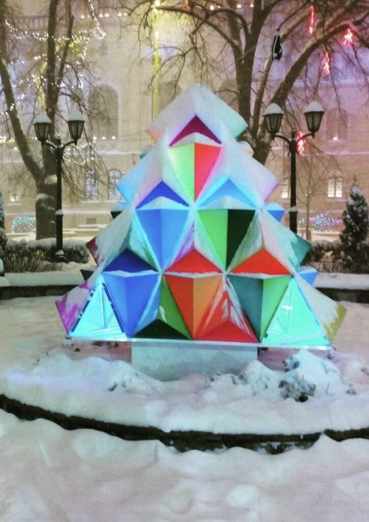 Colorful Christmas tree alternative made with playful materials arranged in a tree shape