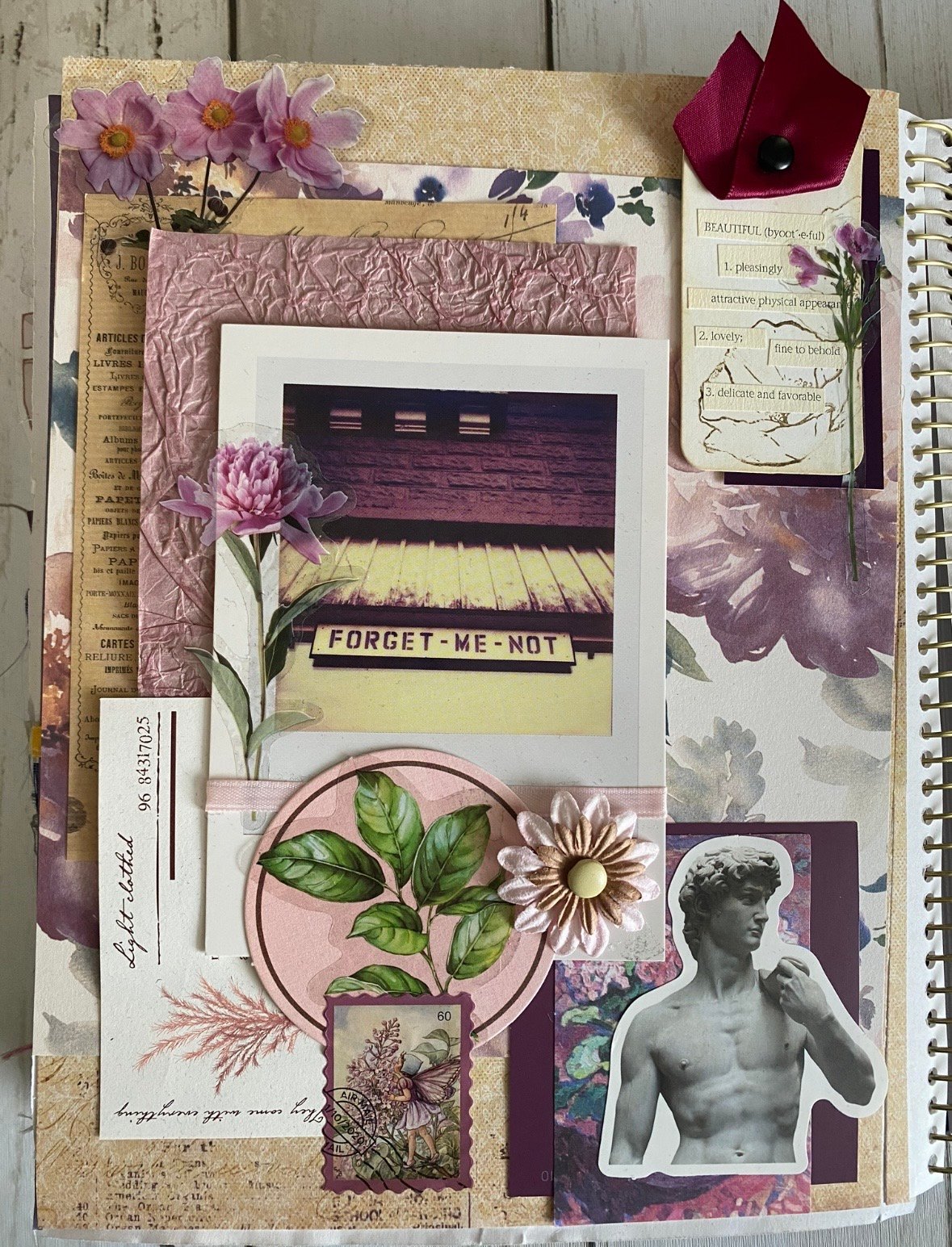 Photo showing a Mayhem Crafters spring garden junk journal layout with layered papers, botanical elements, and spring themed details, featured by slowestuff.com.