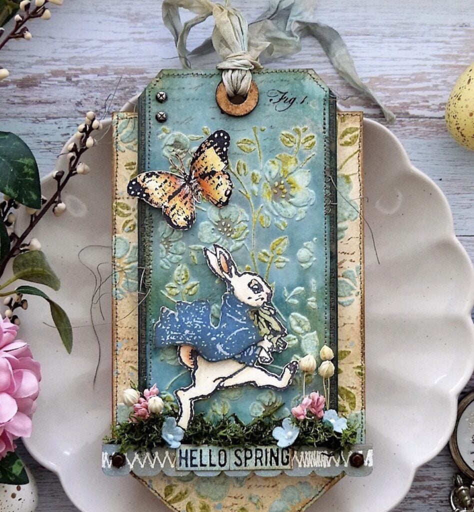 Spring scrapbook tag featuring a rabbit walking with a butterfly in a garden