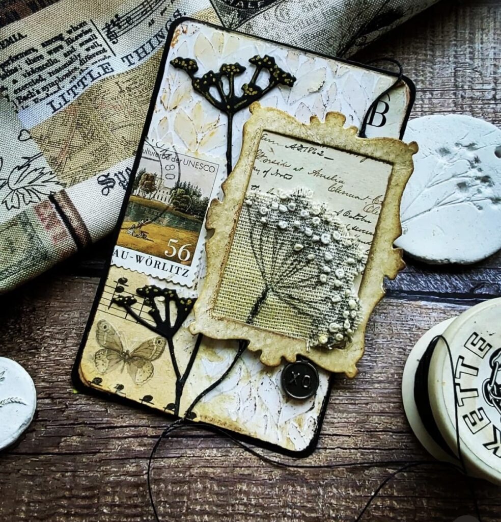 Spring scrapbook card featuring botanical elements in tan, white and black with a picture frame feature