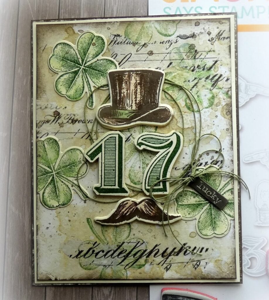 St Patricks Day card with green background a top hat over the number 17