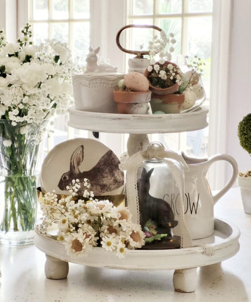 Neutral tiered tray for easter with rabbit plate, white dishware and daisy flowers