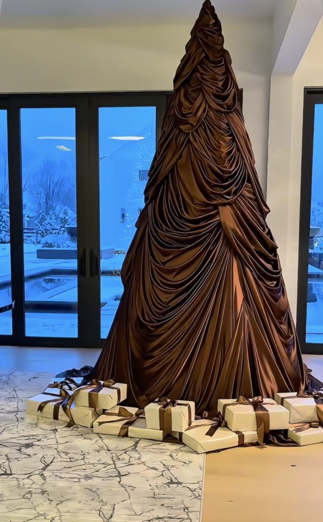 Non-traditional Christmas tree with draped fabric and bold styling and unique festive decorations