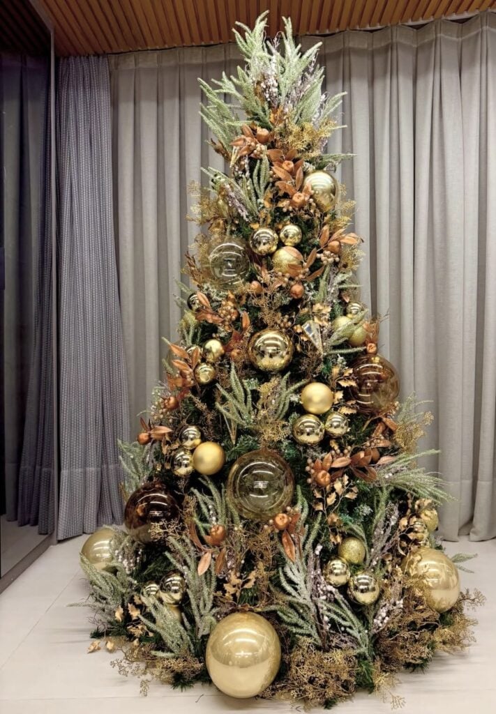 Unusual Christmas tree decor with festive ornaments and non-traditional holiday styling