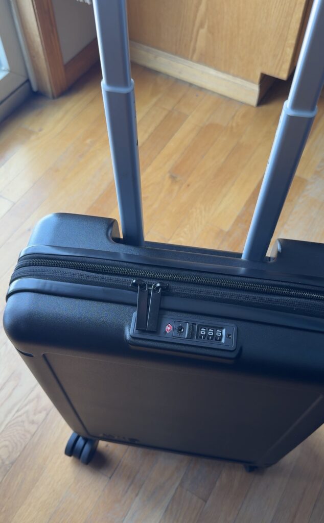 Close up of Avio collapsible carry on luggage TSA combination lock and zipper detail