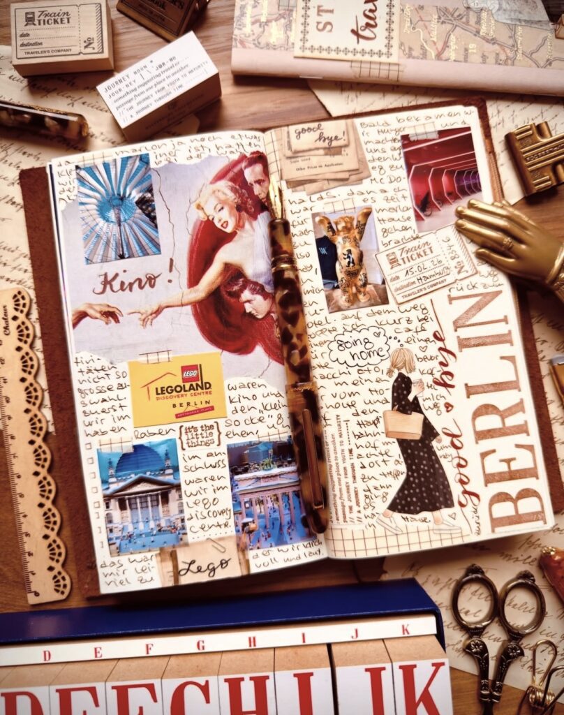 Berlin travel journal spread with “BERLIN” title, Legoland Berlin ticket, handwritten journaling, and collage photos, styled with stamps and desk accessories.