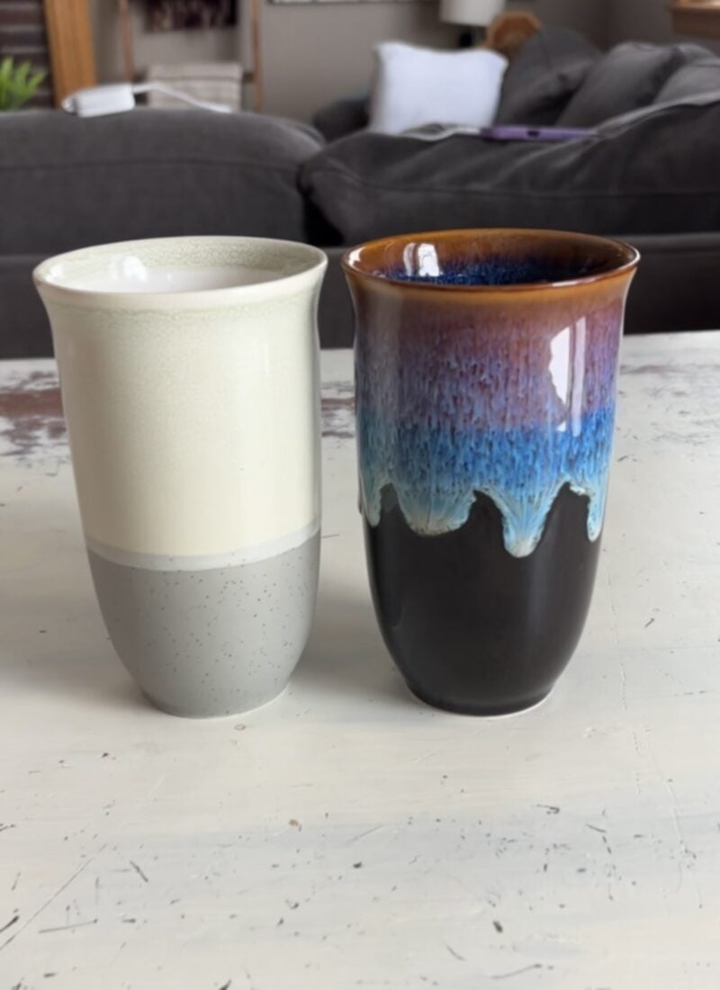 Two nova ceramics travel coffee mugs on a table
