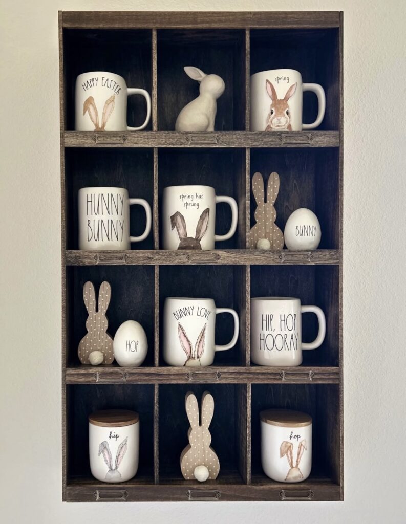 Minimal Easter kitchen cubby shelf decor with bunny mugs, wooden bunny silhouettes, white egg accents, and simple neutral spring styling.