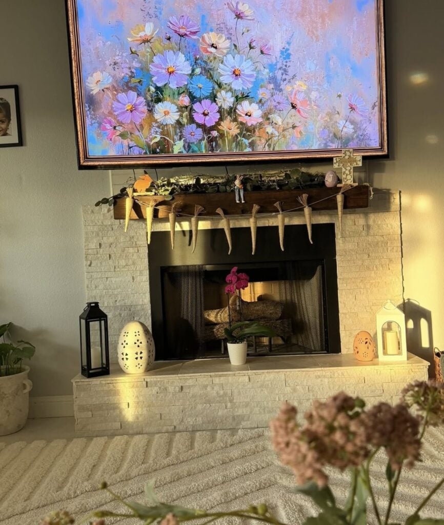 Earthy Easter mantel decor with cabbageware, trailing greenery, rustic bunny accents, and natural spring styling on a warm neutral fireplace.