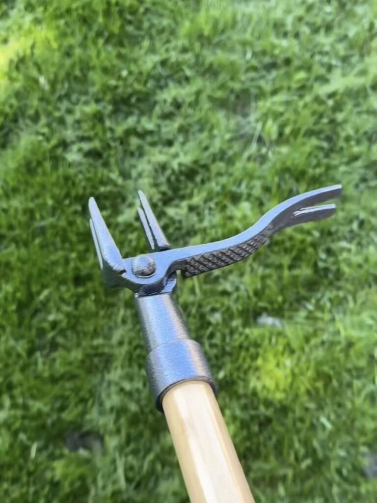 Close up of Grampas stand up weeder with grass background