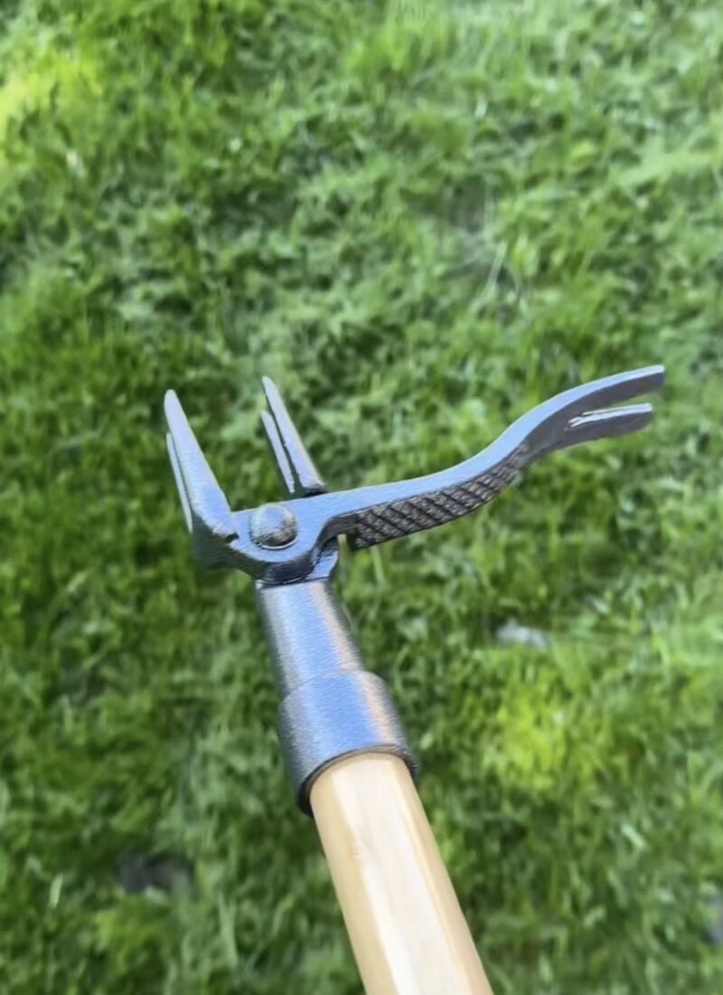 Close up of Grampas stand up weeder with grass background
