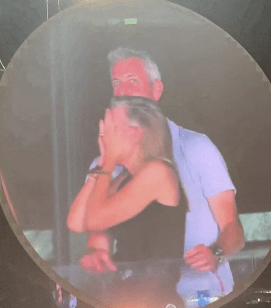Viral Coldplay kiss cam moment showing a surprised couple after realizing they appeared on the stadium's giant screen during the concert.