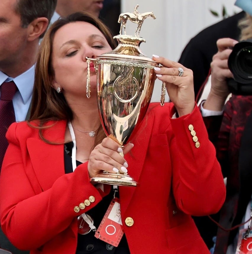 Cherie DeVaux Kentucky Derby Halloween costume idea with a red blazer, trophy and toy horse.