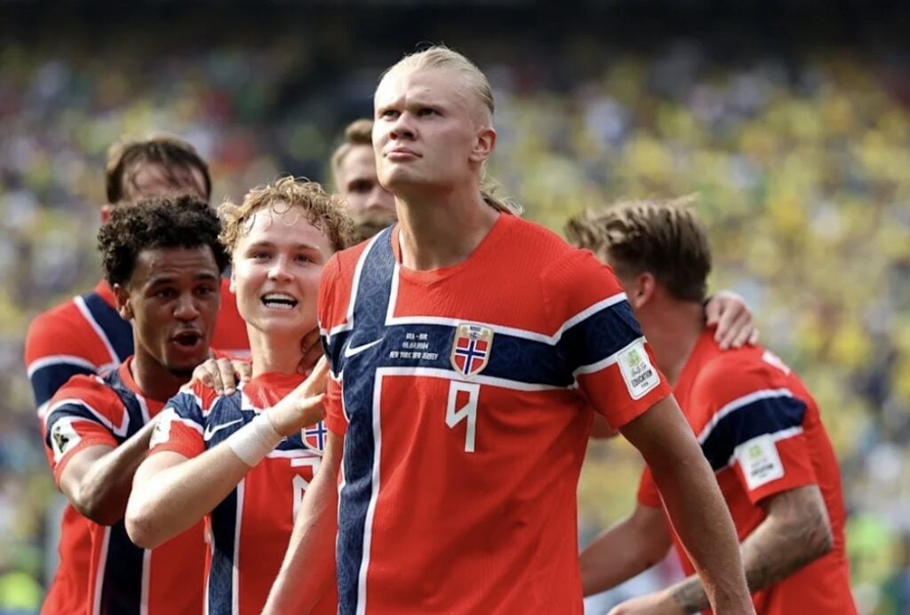 Erling Haaland in a Norway soccer uniform with long blond hair, Viking-inspired Halloween costume inspiration.