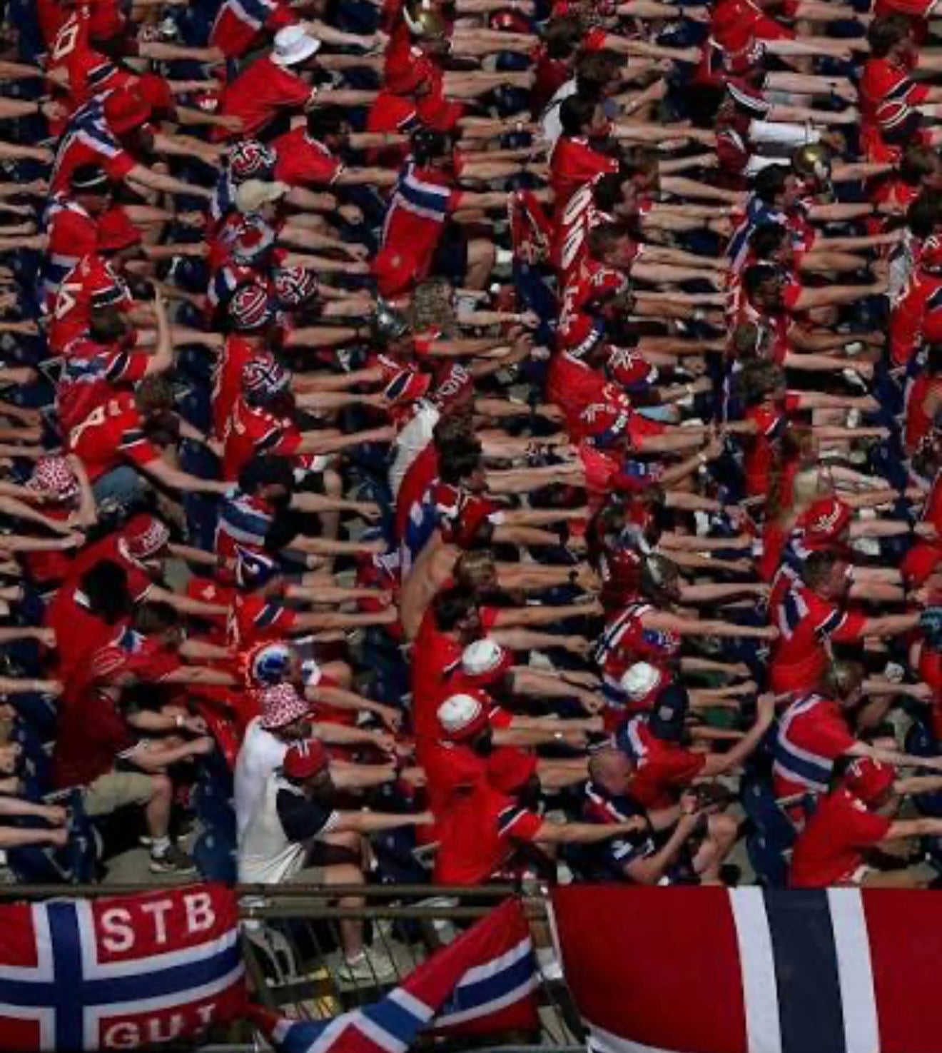 Group of Norwegian soccer fans rowing wearing Norway colors and festive accessories for a Halloween group costume.