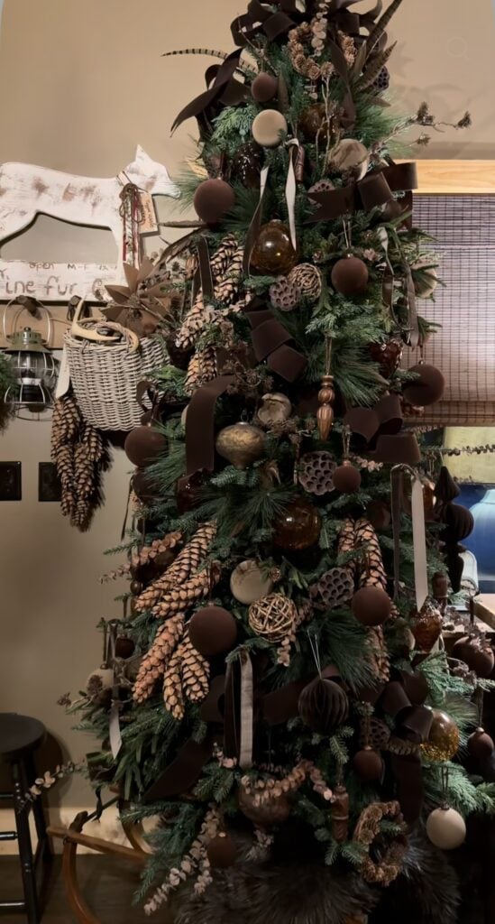 Dark brown Christmas tree decor with deep chocolate ornaments, warm lights, and dramatic holiday styling