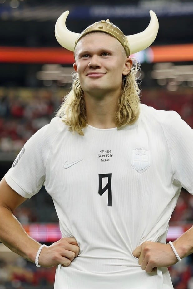 Erling Haaland in white jersey wearing viking hat