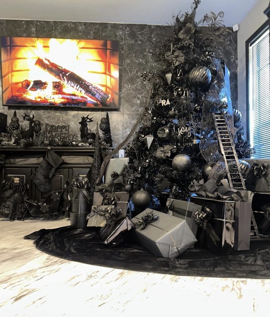 Black Christmas tree decorated with black ornaments and layered dark accents for a bold monochromatic Christmas look.