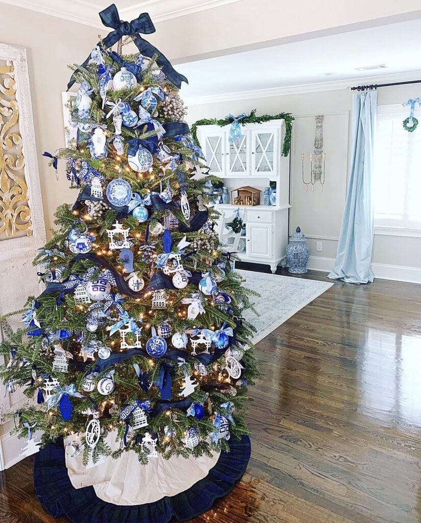 Blue Christmas tree styled with vintage ornaments, nostalgic decorations, colorful details, and warm holiday lights.