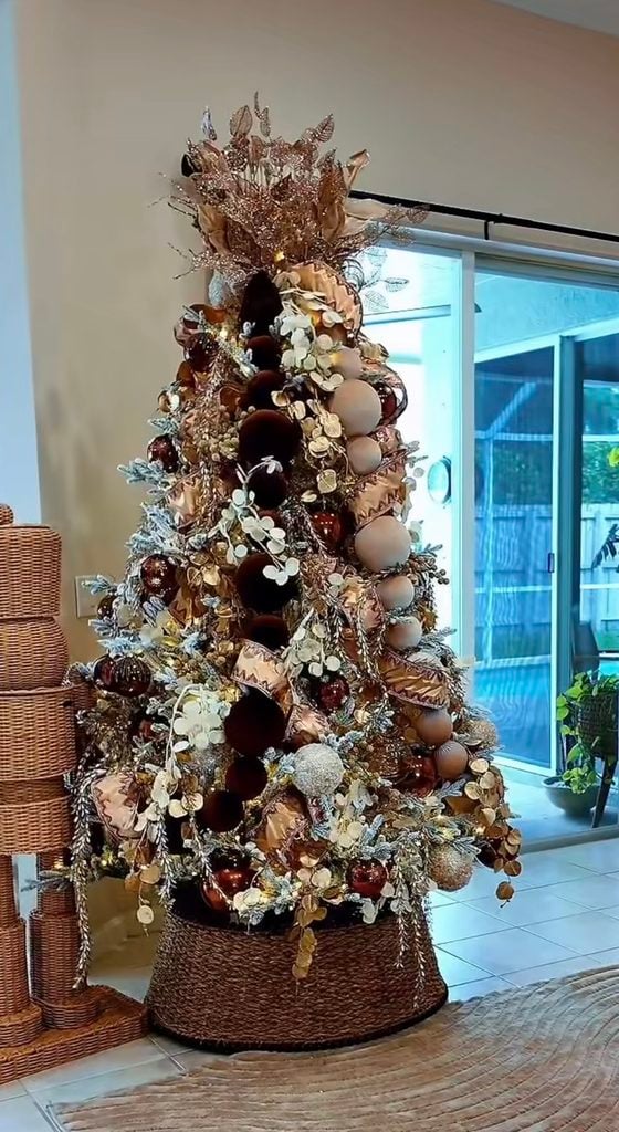 Neutral Christmas trees styled with cream, gold, brown, and natural decorations for a sophisticated holiday look.