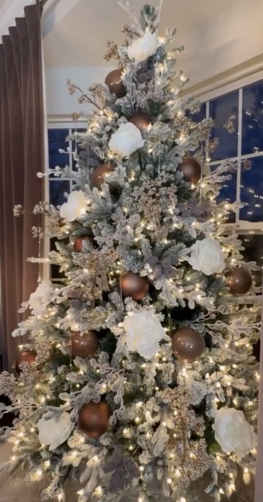 Floral Christmas tree inspiration featuring layered flowers, greenery, ornaments, and decorative botanical stems.