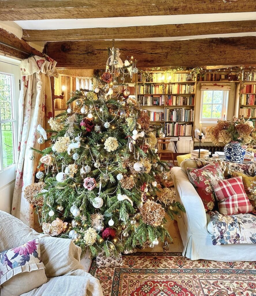 Nostalgic floral Christmas tree decorated with flowers, traditional ornaments, greenery, and warm glowing lights.