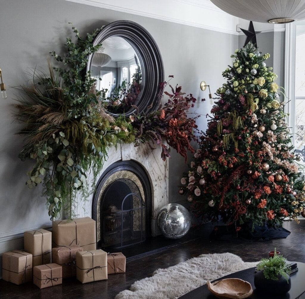 Dark academia floral Christmas tree styled with moody flowers, deep greenery, ornaments, and rich botanical details.