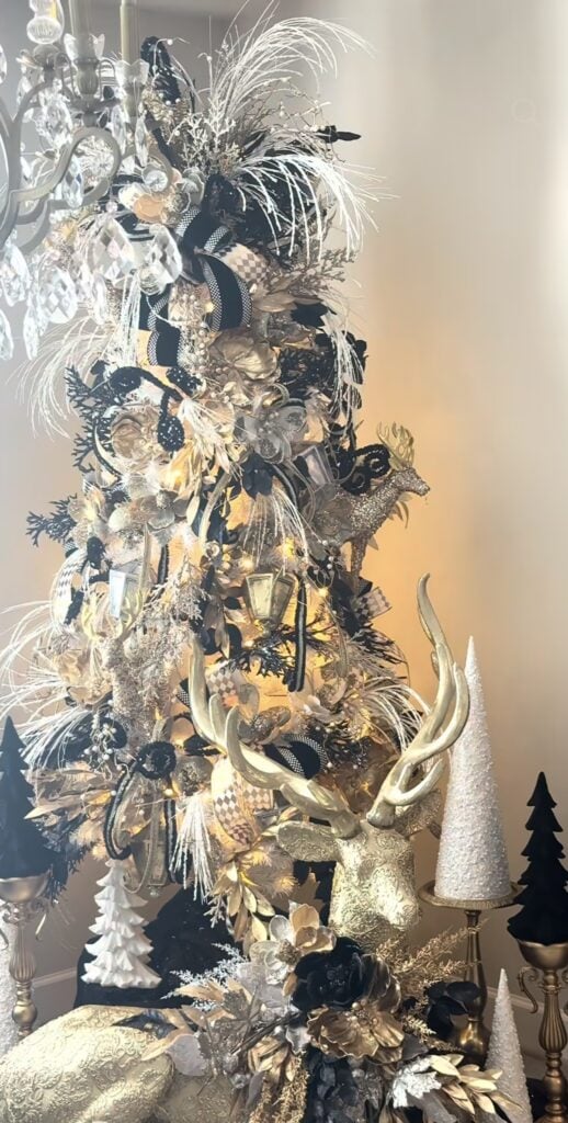 Jeweled black and white Christmas tree decorated with silver ornaments, crystal details, and sparkling metallic accents.