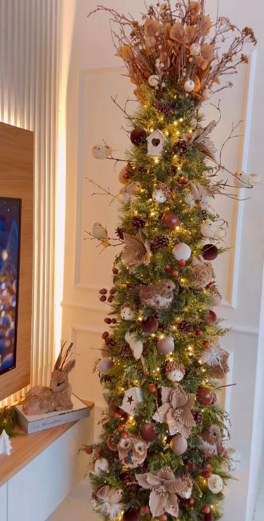 Neutral woodland Christmas tree decorated with earthy colors, forest creatures, natural textures, and organic holiday details.