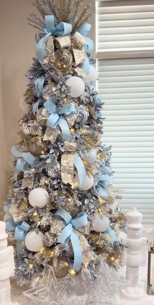 Tiffany blue Christmas tree decorated with aqua ornaments, pale ribbon, sparkling accents, and elegant holiday details.