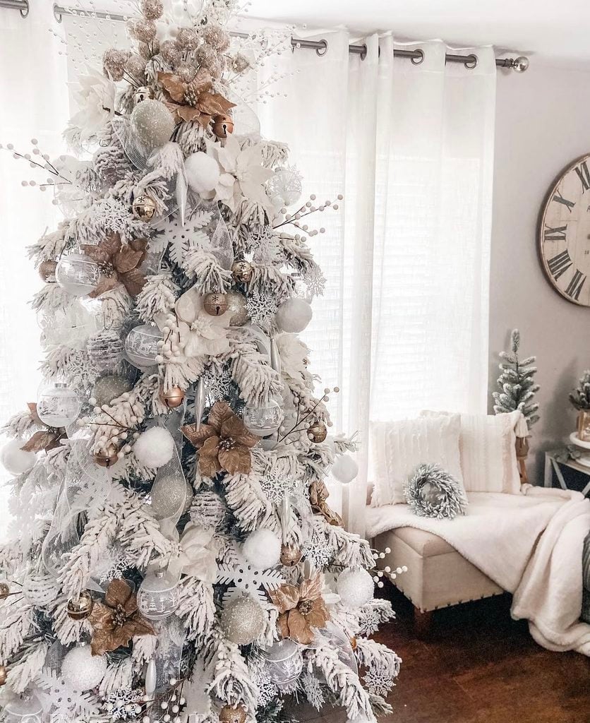 Christmas tree decorated in neutral colors with cream, brown, green, and rustic natural details for a cozy holiday look.