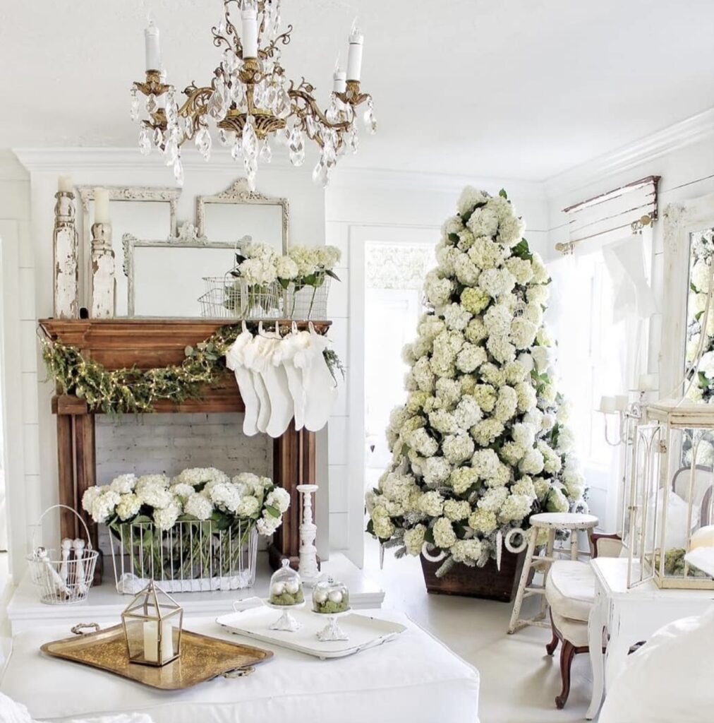 Christmas tree filled with large hydrangea blooms, greenery, ornaments, and botanical stems for a soft layered look.
