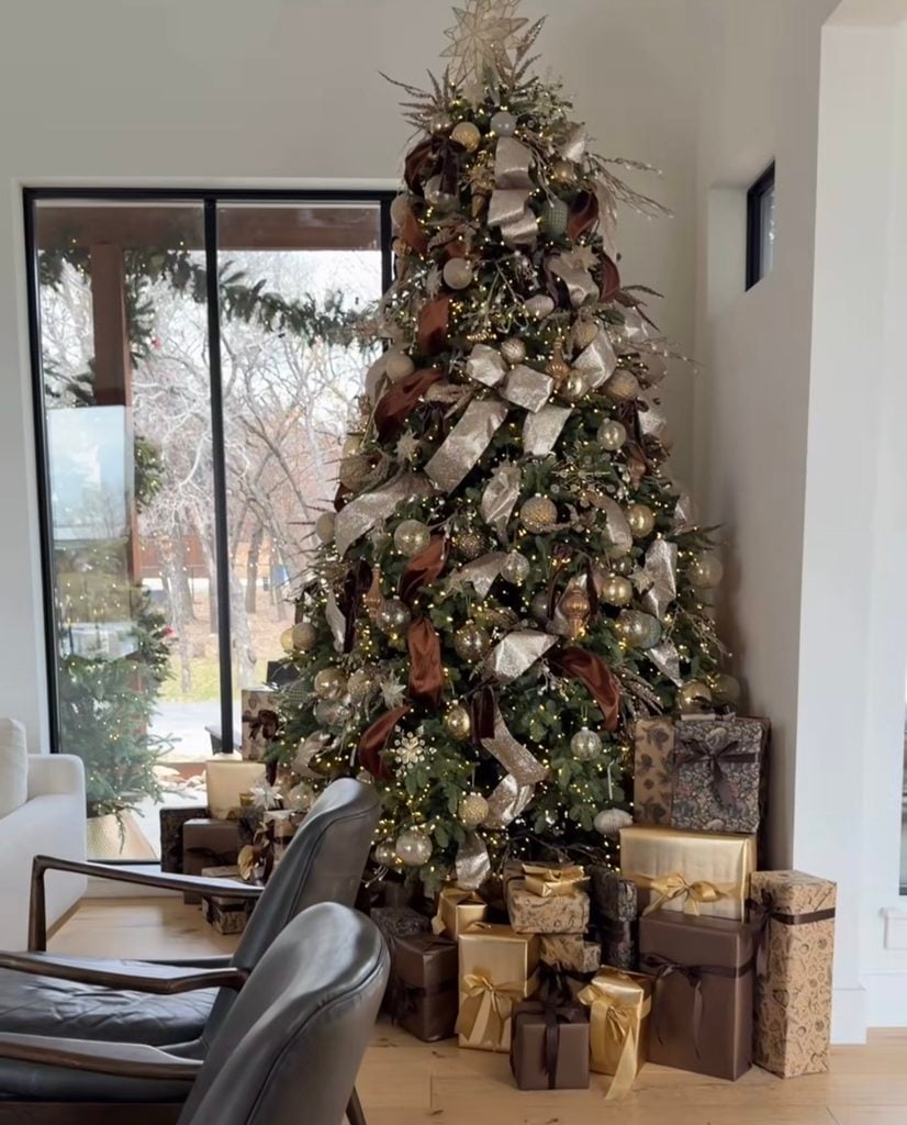 Neutral Christmas tree styled with cream, beige, and natural-toned ornaments in a warm living room.