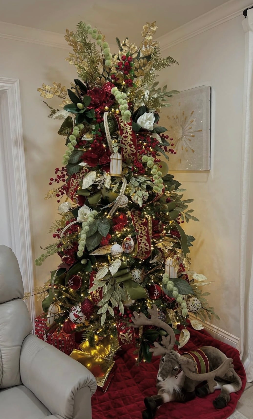 Burgundy Christmas tree inspiration featuring deep red ornaments, layered greenery and warm elegant holiday styling.
