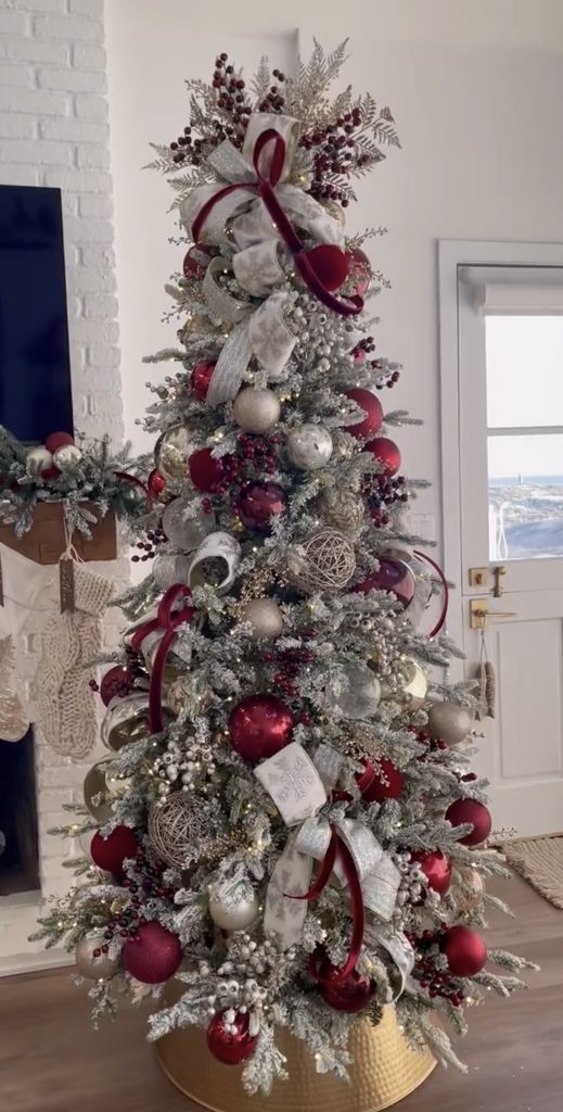 Silver and burgundy Christmas tree with frosted branches, wine-red ornaments, berry sprays and sparkling metallic accents.