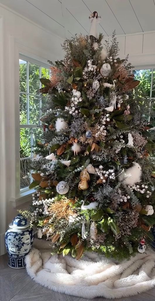 Woodland neutral Christmas tree decorated with natural elements, branches, pinecones, earthy ornaments, and forest-inspired details.