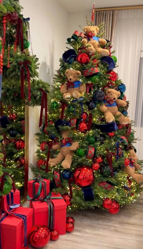 Playful Ralph Lauren Christmas tree decorated with oversized teddy bears, tartan ribbon, navy and red ornaments, warm lights, and classic preppy holiday details.
