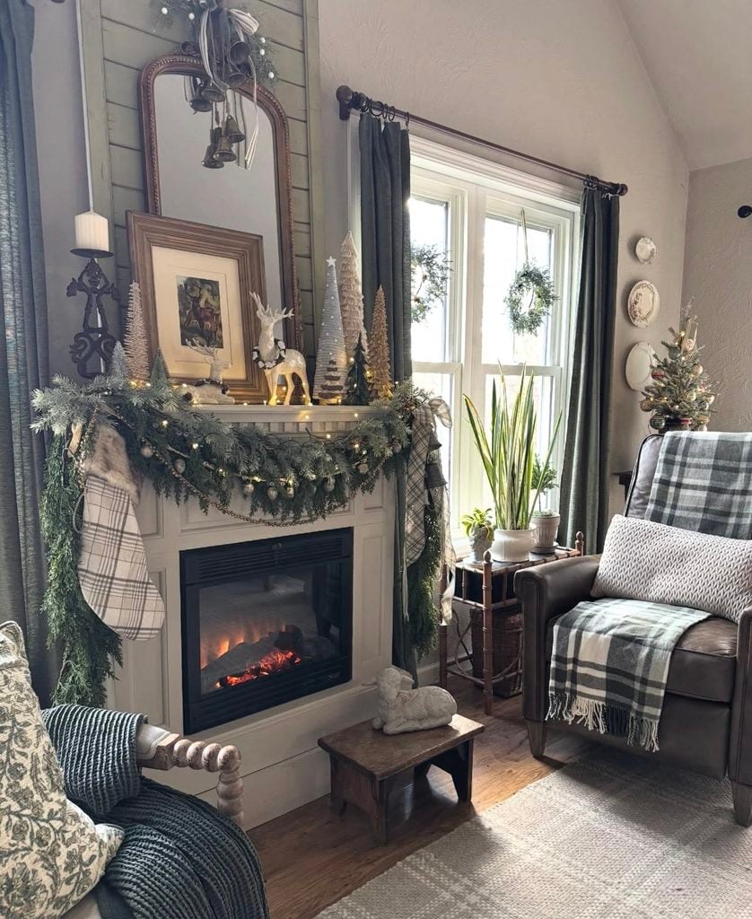 Christmas fireplace mantel inspiration with layered garland, holiday decorations, candles, and warm seasonal styling.